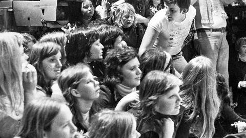 A group of teenagers in the studio audience during the taping of a tv show