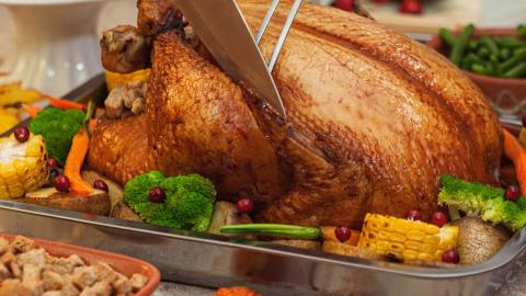A roast chicken and vegetables on a platter. 