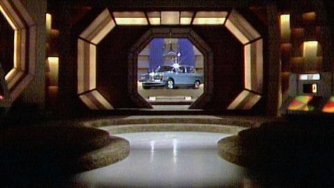 Shot of the interior of the studio of Sale of the Century. A blue car is being revealed through a lit up window.