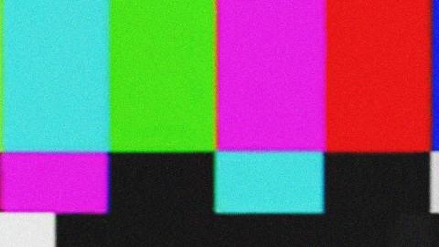 Brightly coloured vertical bars from a TV test pattern screen.