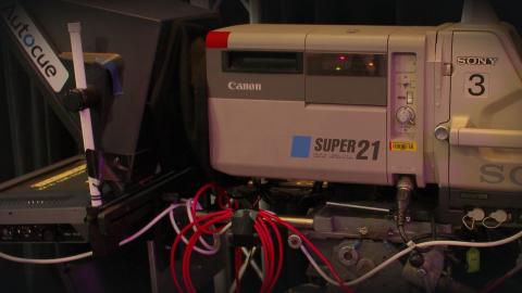 Close up of studio camera equipment, showing a Super 21 camera and autocue machine.
