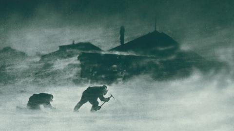 Two men leaning into a blizzard