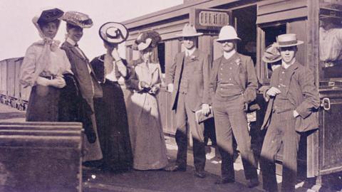 The Corrick family standing in front of a train. c.1906