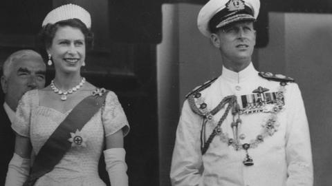 Queen Elizabeth II and Prince Philip in Australia. Sir Robert Menzies is standing behind them.