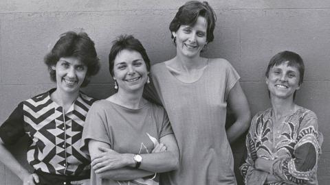 Filmmakers Margot Nash, Megan Mcmurchy, Jeni Thornley and Margot Oliver standing in front of a wall smiling for the camera.