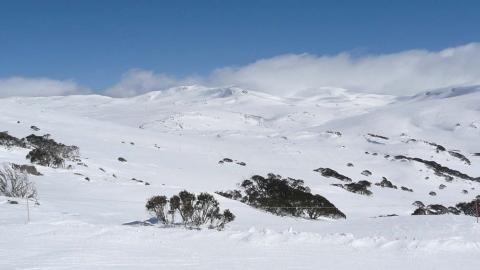 View of snow-covered mountain range towards Mount Kosciuszko in winter