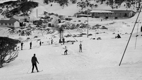 Skiers skiing down a slope in the early 1960s