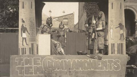 Four actors in costume pose on a horse-drawn trailer promoting The Ten Commandments in 1925