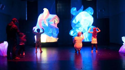 Children stand in front the interactive light sculpture Fractured Heart at the NFSA