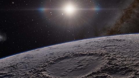The surface of the Moon with the Sun visible in the background