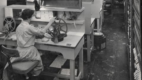 A woman operating a film winder at a film winding bench at Channel 7, Sydney. Circa 1950s. 
