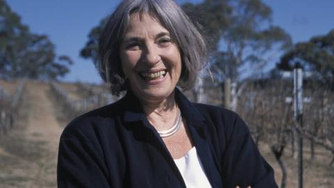 Betty Churcher standing outside, laughing
