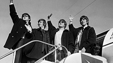 The Beatles leaving Sydney The Beatles (from left to right: Paul McCartney, Ringo Starr, John Lennon, George Harrison) wave to crowds in Sydney as they prepare to board a plane to New Zealand in June 1964.