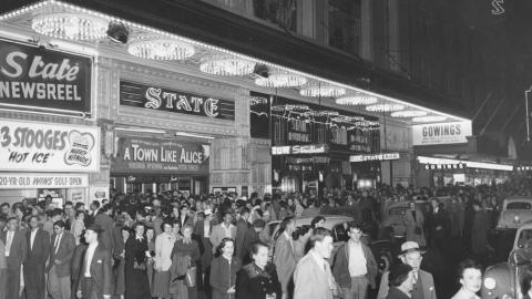 A crowd of patrons in 1950s Sydney outside the State Theatre which is showing A Town Like Alice