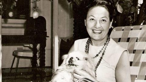 Binny Lum holding her dog, Ming. Circa 1960s.