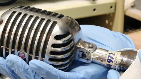 Oral history - Musicians A NFSA curator holds a vintage microphone