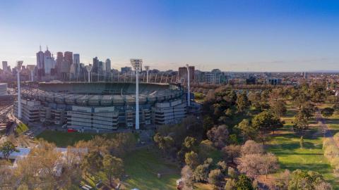 An aerial view of the Melbourne Cricket Ground with the city skyline