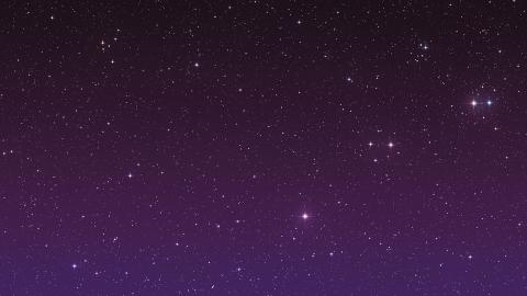 A purple black sky with twinkling stars