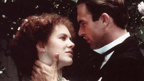 Judy Davis as Sybylla and Sam Neill as Harry embrace. He is touching her neck and she is touching his arm. They look at each other lovingly.
