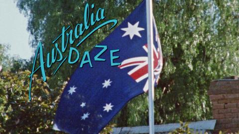 An Australian flag flying on a flag pole with the film title 'Australia Daze' superimposed over the top.